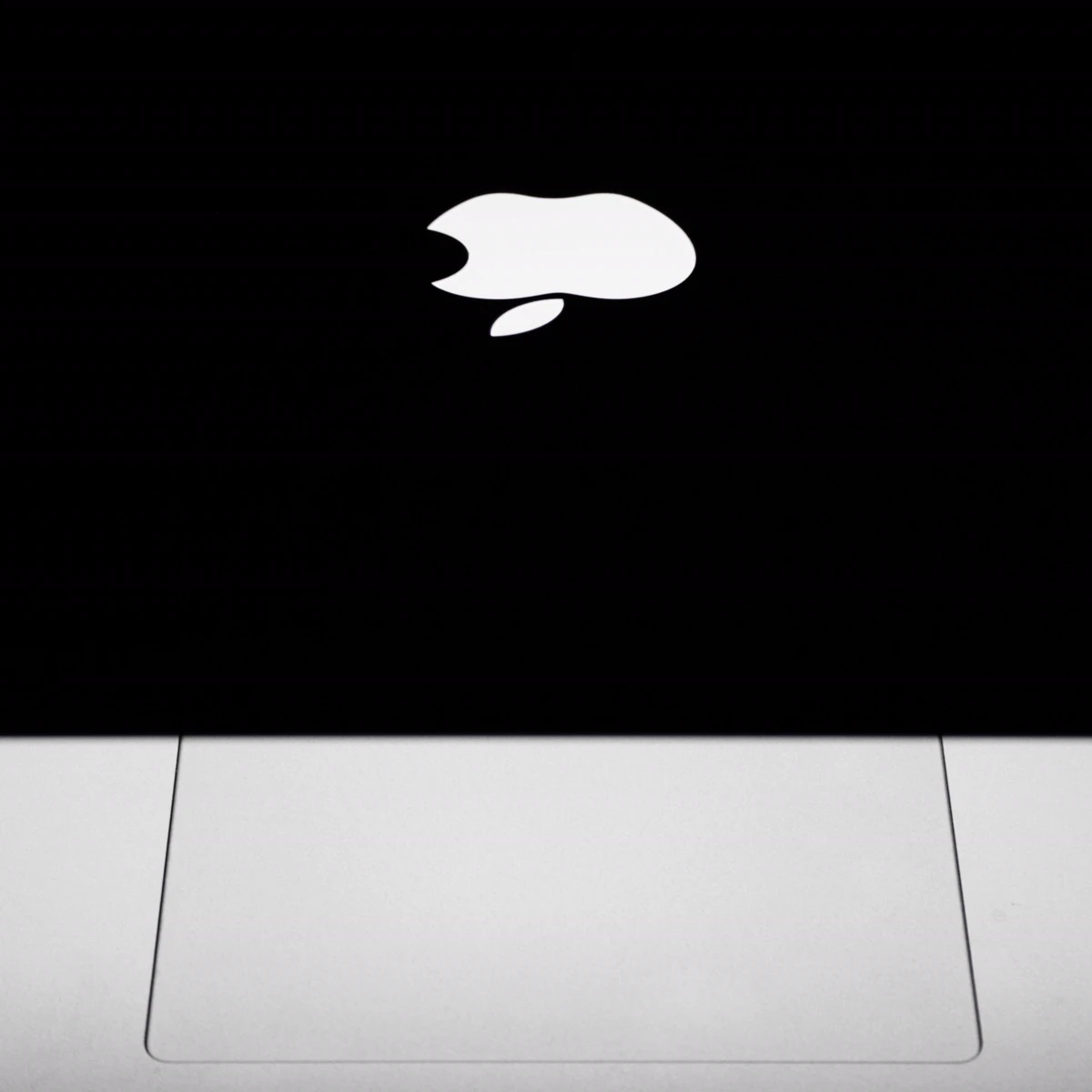 Illuminated Apple logo on a MacBook display
