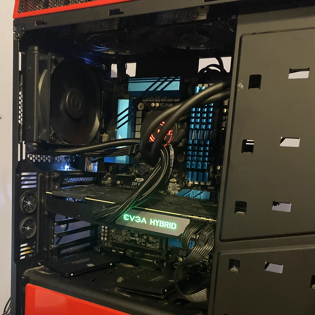 Custom PC build with red accent lighting and liquid cooling